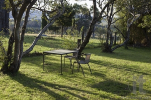Table and chairs in a country house garden. Bingie. Nsw. Australia.
