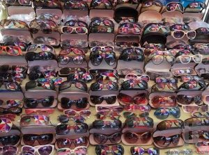 Colourful umbrella reflected in sunglasses on street market. Yangon. Myanmar.