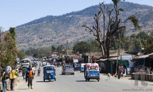 HIRNA, OROMIA REGION, ETHIOPIA - DECEMBER 22, 2013: There is no busy traffic on the main street of a small provincial town. Tuk-tuks are the major mean of transport.