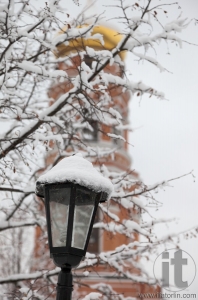 Bell tower and streetlight. Orthodox monastery Davidova Pustin in winter. Chekhov. Moscow region. Russia.