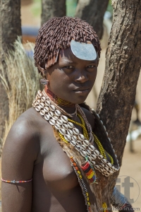 Hamar woman seller at village market.
