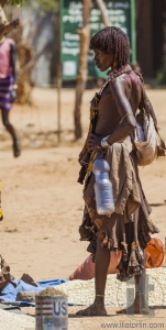 Hamar woman seller at village market.