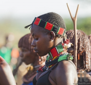 Portrait of young Hamar woman at bull jumping ceremony.