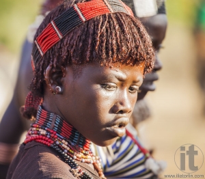 Portrait of young Hamar woman at bull jumping ceremony.