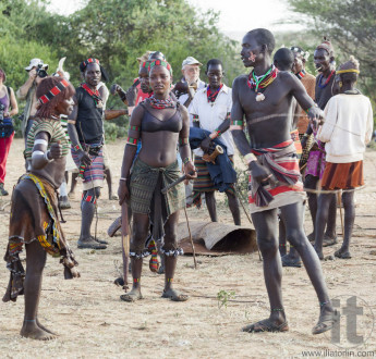 Hamar woman is whipped in a preparation to a bull jumping ceremony.