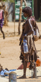 Hamar woman seller at village market.