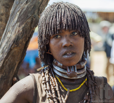 Hamar woman seller at village market.