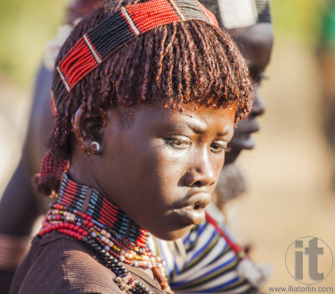 Portrait of young Hamar woman at bull jumping ceremony.