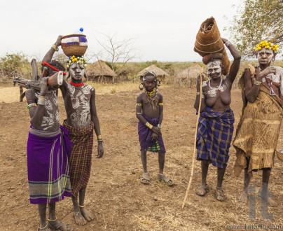 Children and Woman from Mursi tribe in Mirobey village. Omo Vall