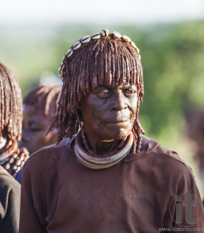 Portrait of mature Hamar woman at bull jumping ceremony.