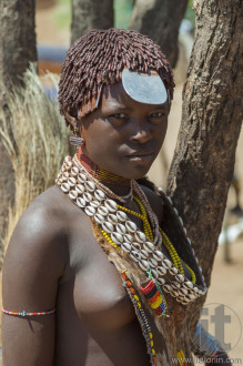 Hamar woman seller at village market.