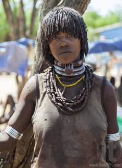 Hamar woman seller at village market.