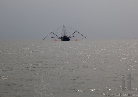 Fishing boat in usual Hong Kong's misty weather. Hong Kong.