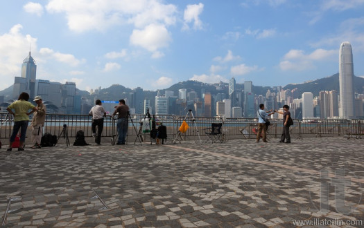 Photographers reserve spots for the evening fireworks. Hong Kong.