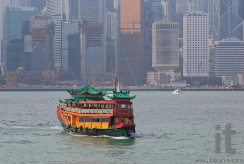 Traditional Chinese Boat on Victoria Harbour coming to collect tourists. Hong Kong.