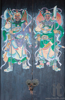 Two warriors (door gods) on the gate of Yeung Hay Temple. Hong Kong.