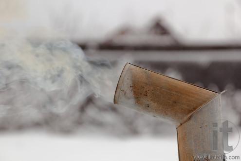 Smoke from samovar's chimney in winter. Moscow region. Russia.