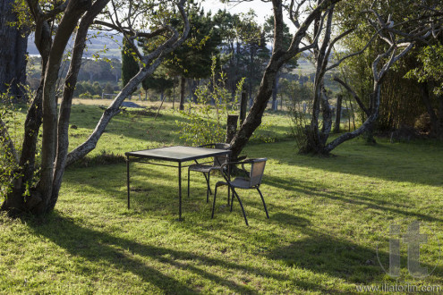 Table and chairs in a country house garden. Bingie. Nsw. Australia.
