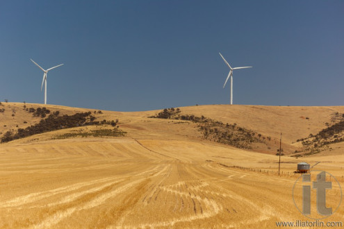 Rural landscape with wind generators distorted by hot air. South Australia