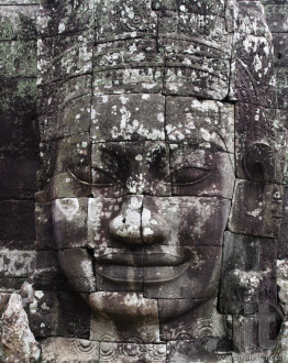 Close-up of smiling face of teh king Jayavarman VII  in the temple of Bayon, Angkor Wat, Siem Riep, Cambodia.