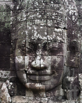 Close-up of smiling face of teh king Jayavarman VII in the temple of Bayon, Angkor Wat, Siem Riep, Cambodia.