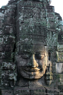 Close-up of smiling face of the king Jayavarman VII in the temple of Bayon, Angkor Wat, Siem Riep, Cambodia.