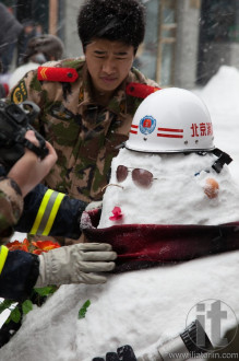 The biggest snowstorml in 60 years. Fire crew making snowmen in Qianmen Dajie. Beijing. China.