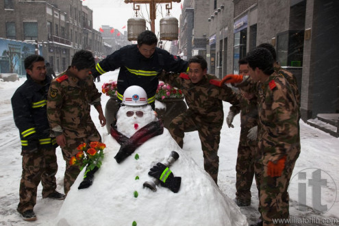 The biggest snowstorms in 60 years. Fire crew making snowmen in Qianmen Dajie.Beijing, China.