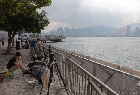 Photographers reserve spots for the evening fireworks. Hong Kong.