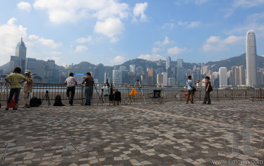 Photographers reserve spots for the evening fireworks. Hong Kong.