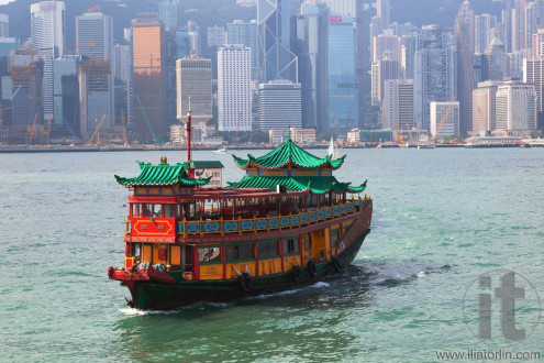Traditional Chinese Boat on Victoria Harbour coming to collect tourists. Hong Kong.