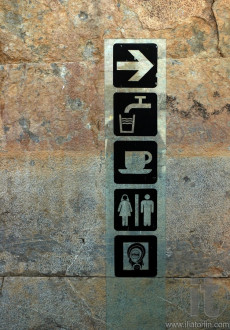 Glass sign post to toilets, cafe, drinking water in Persepolis, Iran
