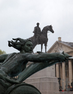 Detail of woman and dolphins fountain in Trafalgar Square. London. UK.