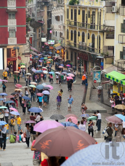 People under colourful umbrellas. Rainy day. Macau. China.