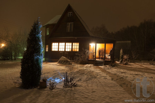 Russian county house (dacha) and decorated Christmas tree. Moscow region. Russia.