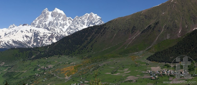 Double peaks of Mt. Ushba and Mulakhi Village. Svaneti. Georgia.