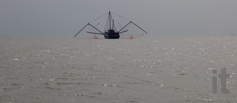 Fishing boat in usual Hong Kong's misty weather. Hong Kong.