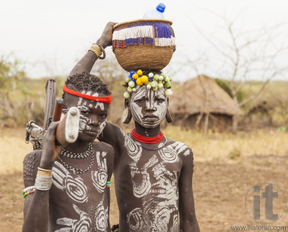 boys from Mursi tribe with machine gun in Mirobey village. Omo V