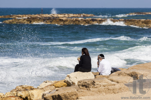 Couple at the seashore enjoys the view. Tel Aviv, Israel